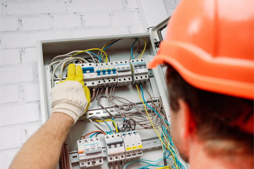 electrician doing wiring on electrical box